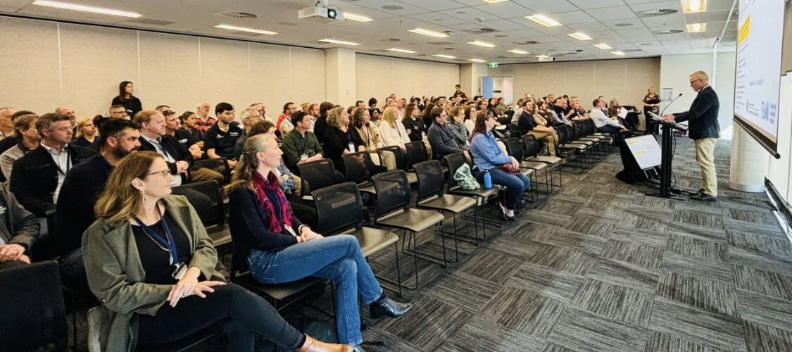 Scientists, interested members of the public and speakers sit at the Flow-MER Forum 2024, held on Ngunnawal Country.